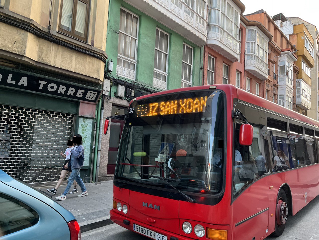 Bus greeting passersby on a street of A Coruña on St. John's Eve