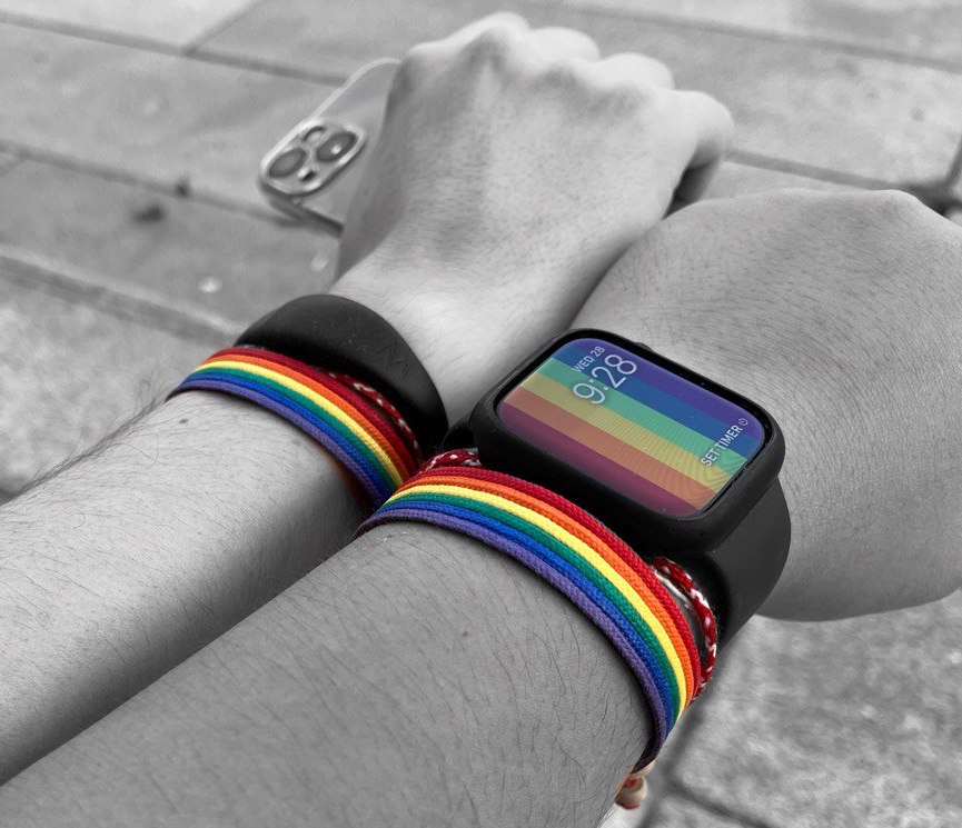 An LGBTQ couple proudly showing their Rainbow Bracelet