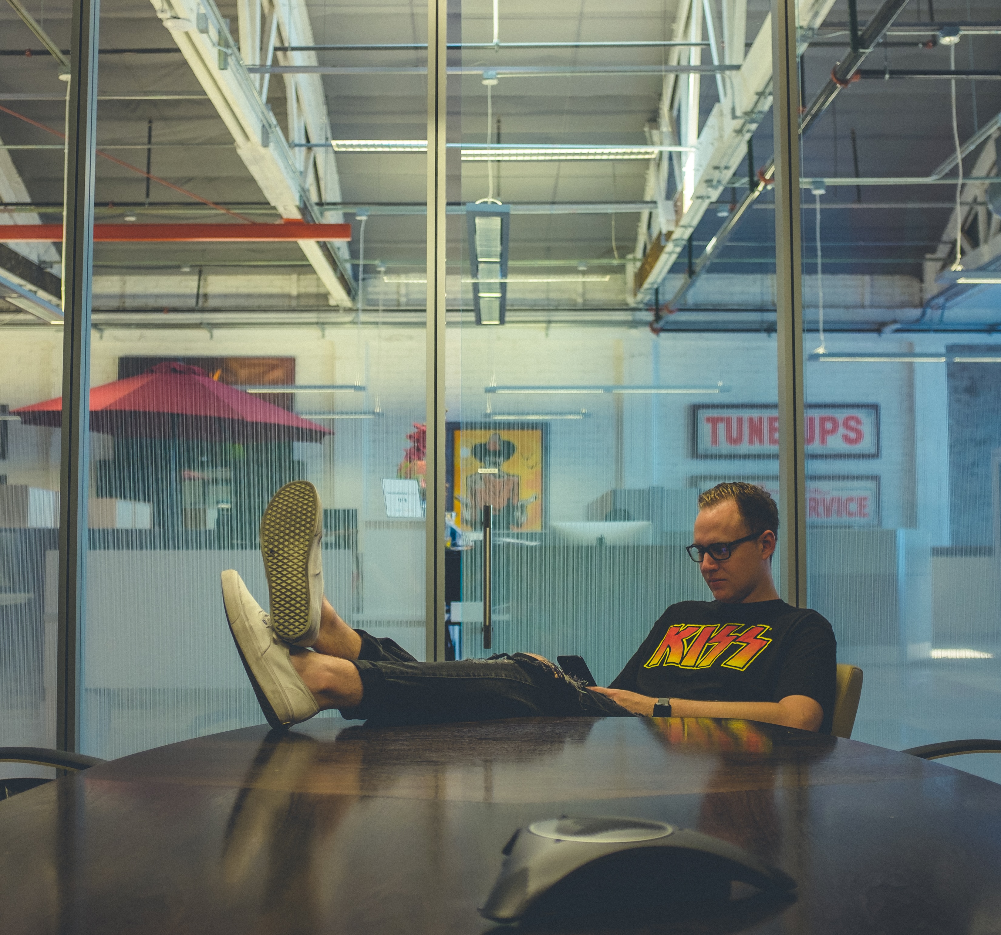 Man sitting with feet on desk.